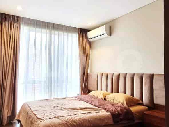 Bedroom with a bed, air conditioning, and curtains.