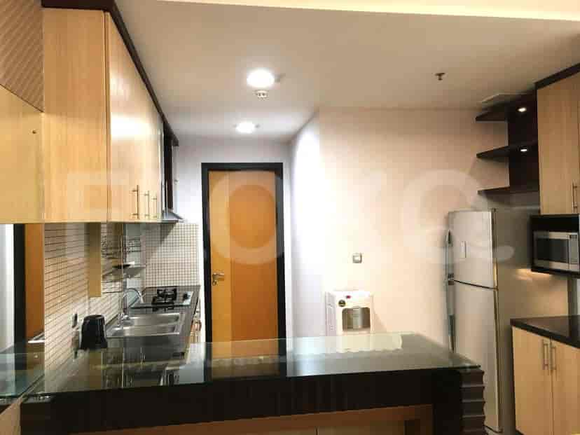 A modern kitchen with stainless steel appliances, including a refrigerator and microwave.