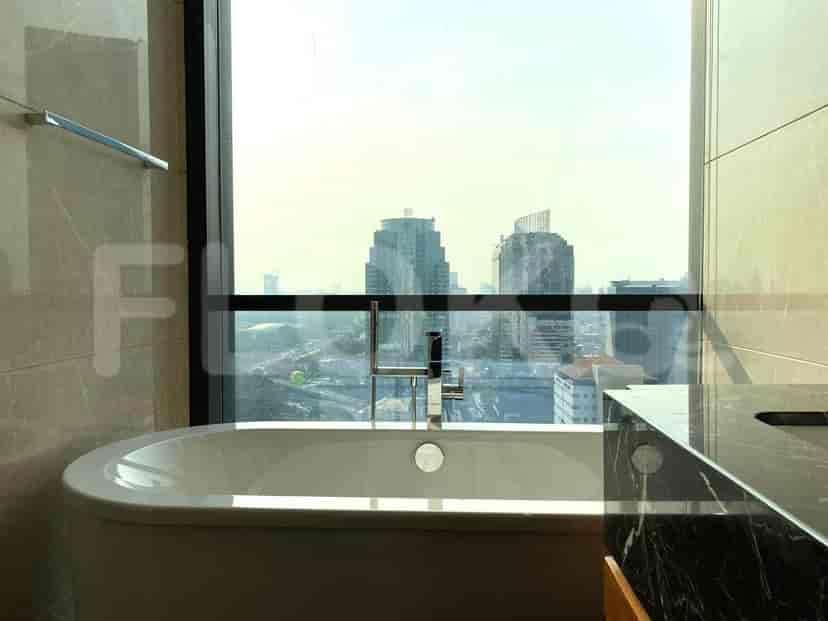 A bathroom with a bathtub and a view.
