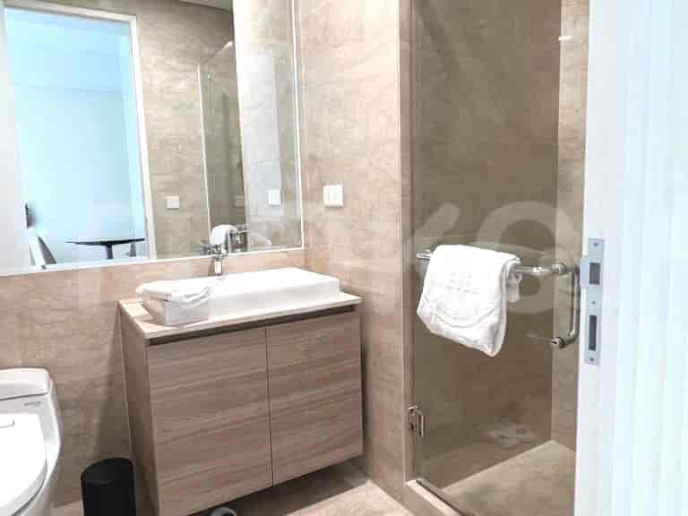 Modern bathroom with a sink, shower, and mirror.