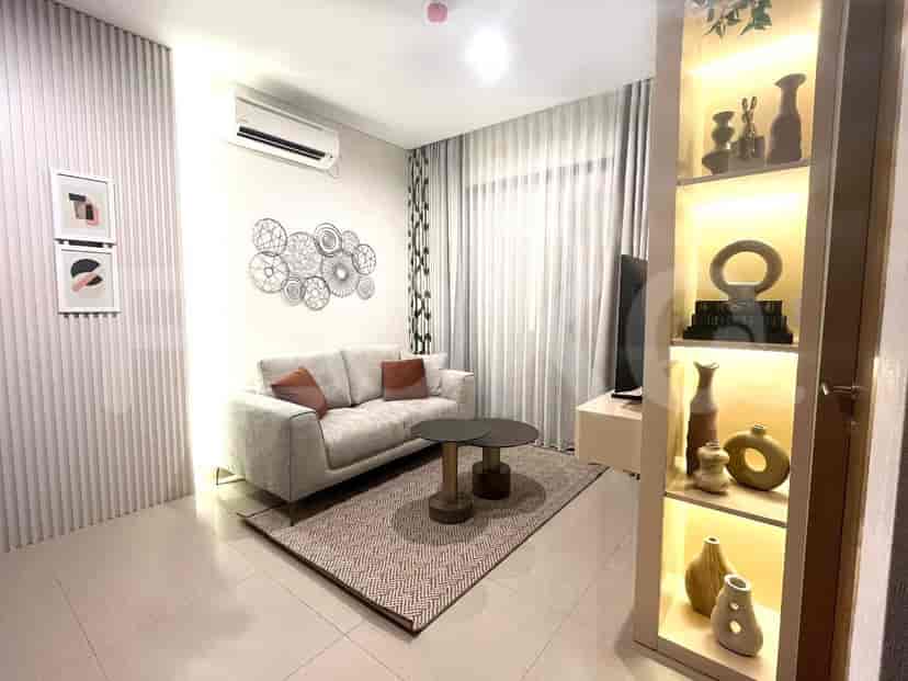 A modern living room with a grey sofa, coffee table, and decorative wall art.