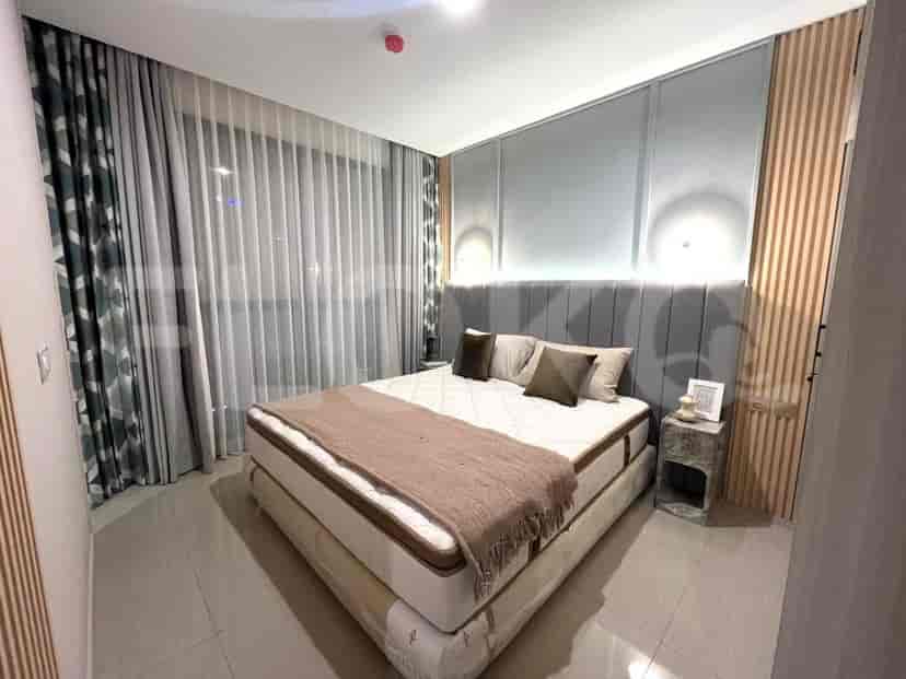 A contemporary bedroom with a king-size bed, bedside table, and large window.