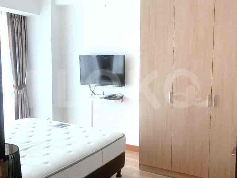 Bedroom with bed, wardrobe, and wall-mounted TV.