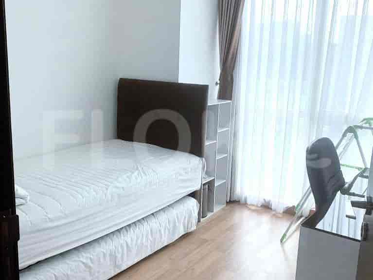A small bedroom with a single bed and simple furnishings.
