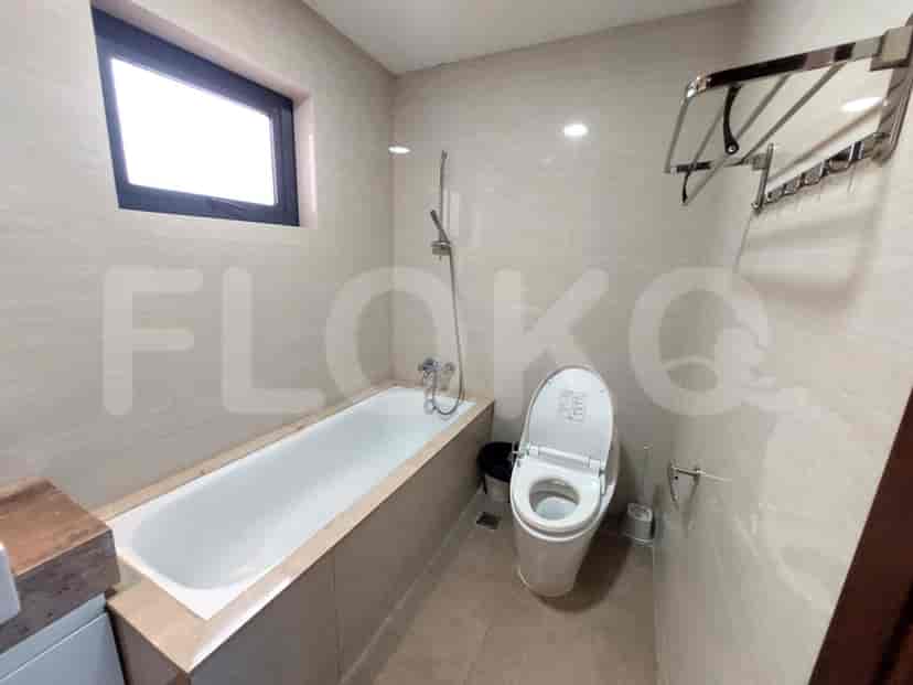A bathroom with a bathtub and a toilet.
