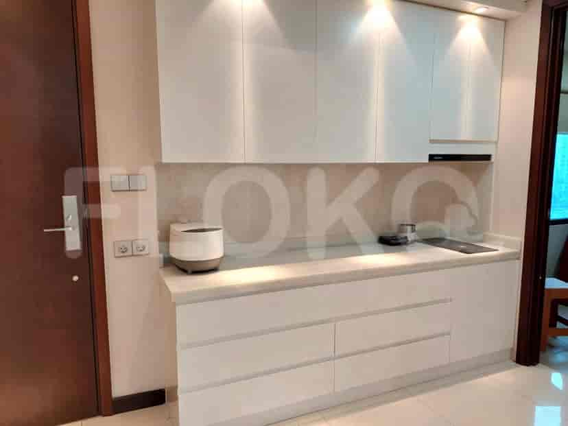 A modern kitchen with white cabinets and appliances.