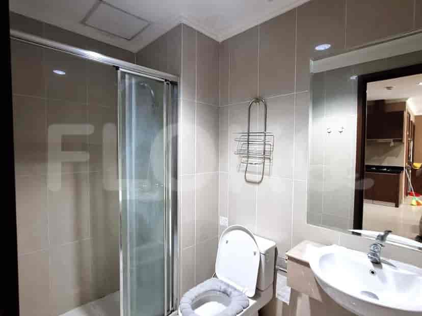 A bathroom with a toilet, sink, and shower.