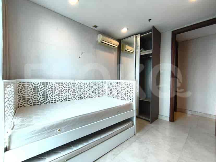A second bedroom with a single bed and a built-in wardrobe.