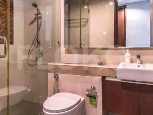 A modern bathroom with a shower, toilet, and sink area.