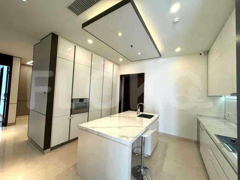 A modern kitchen with a white island, marble countertop, and sleek cabinetry.