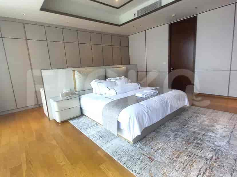 A luxurious master bedroom featuring a large bed, elegant decor, and a spacious layout.