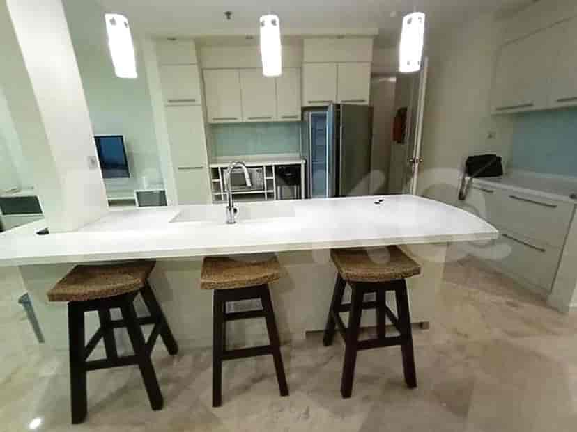 A modern kitchen with a breakfast bar and stools.