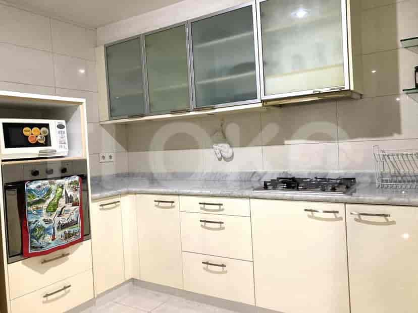A kitchen with light cabinets, a gas stove, and a microwave.