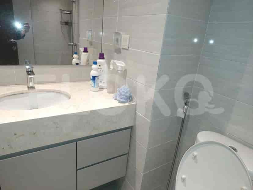 A bathroom with a sink, mirror, and toilet.