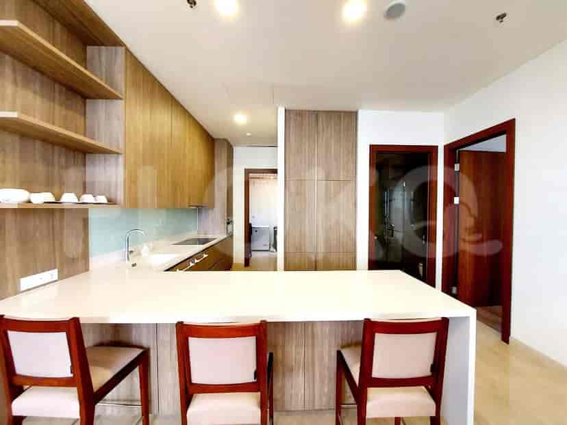 Modern kitchen with wood cabinets, a breakfast bar, and a clean design.