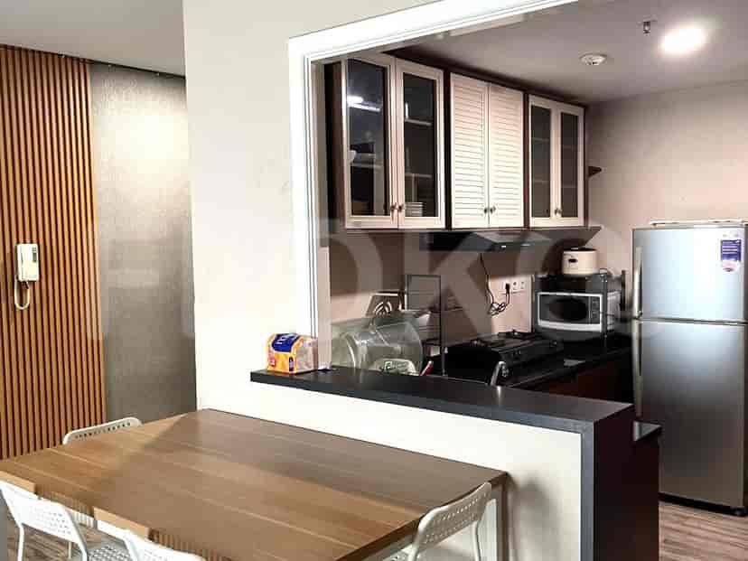 A modern kitchen with white cabinets and appliances.