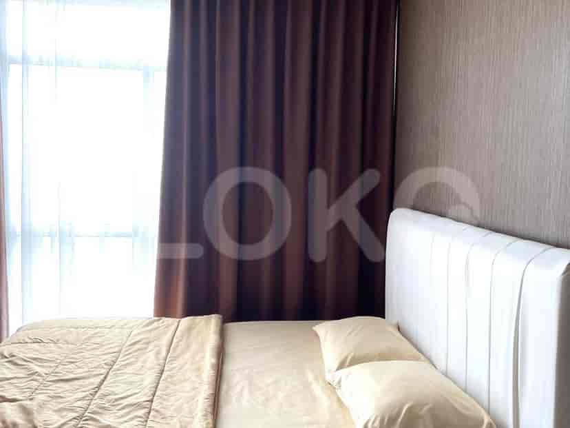 A cozy bedroom with a double bed and brown curtains.