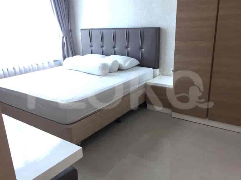 Bedroom with bed, nightstand, and wardrobe.