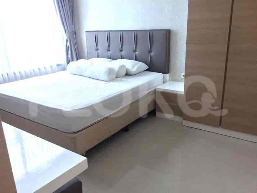 Bedroom featuring a double bed, nightstand, and a window.