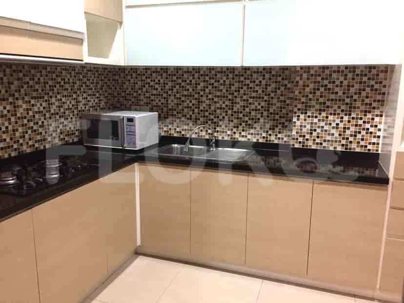 Kitchen with cabinets, stove, and microwave.