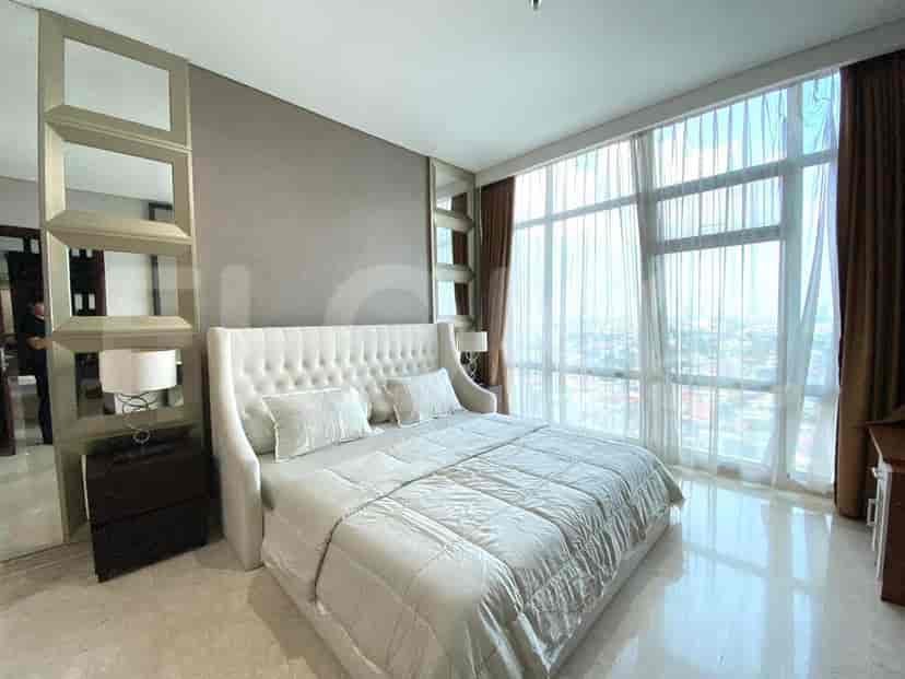 Spacious bedroom with a large bed and floor-to-ceiling windows.