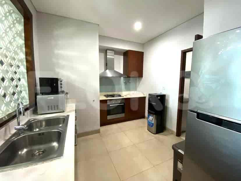Modern kitchen with stainless steel appliances and wooden cabinets.