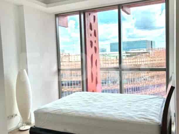A bedroom featuring a bed and large windows.