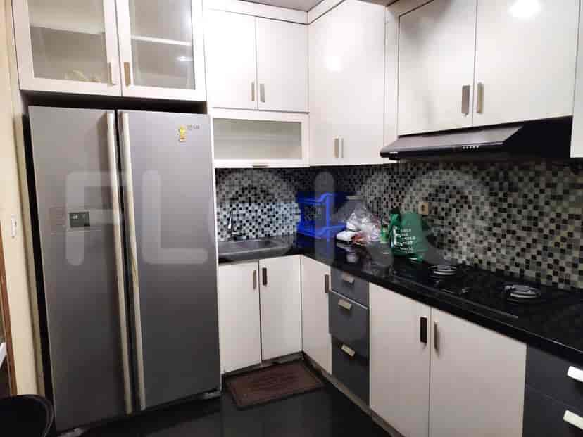 Functional kitchen with a refrigerator, cabinets, and essential appliances.