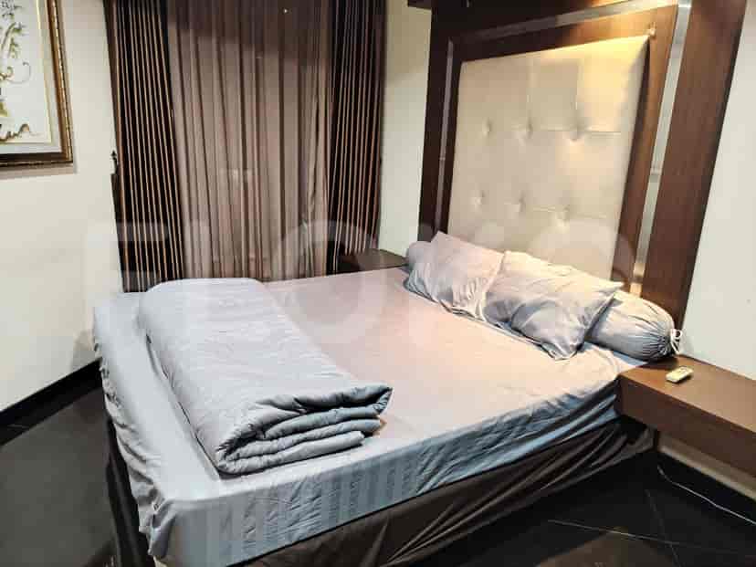 A well-lit bedroom with a large bed, side tables, and a simple, elegant design.
