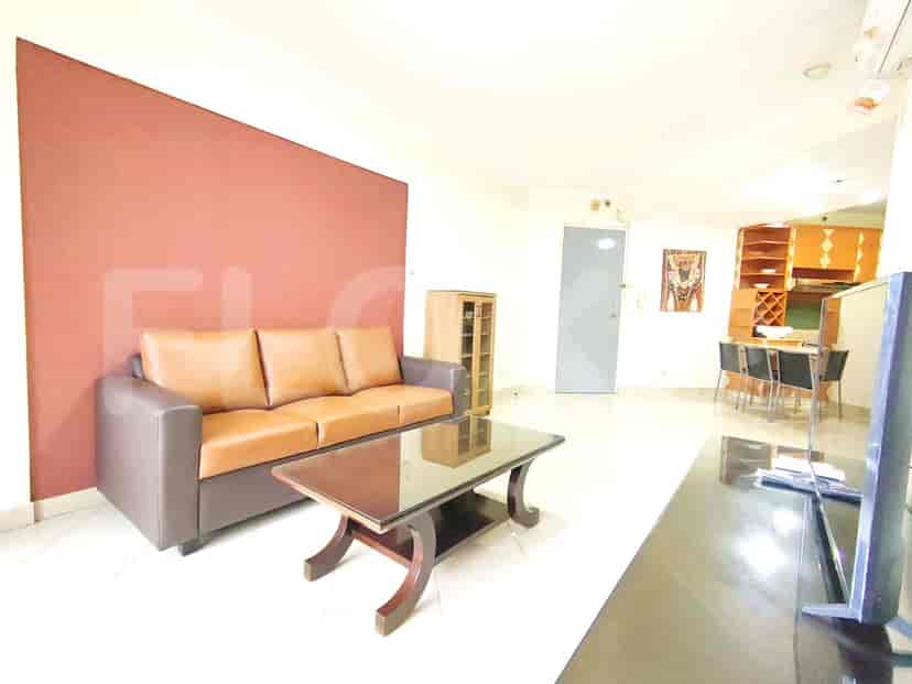 A living room with a sofa, coffee table, and television.