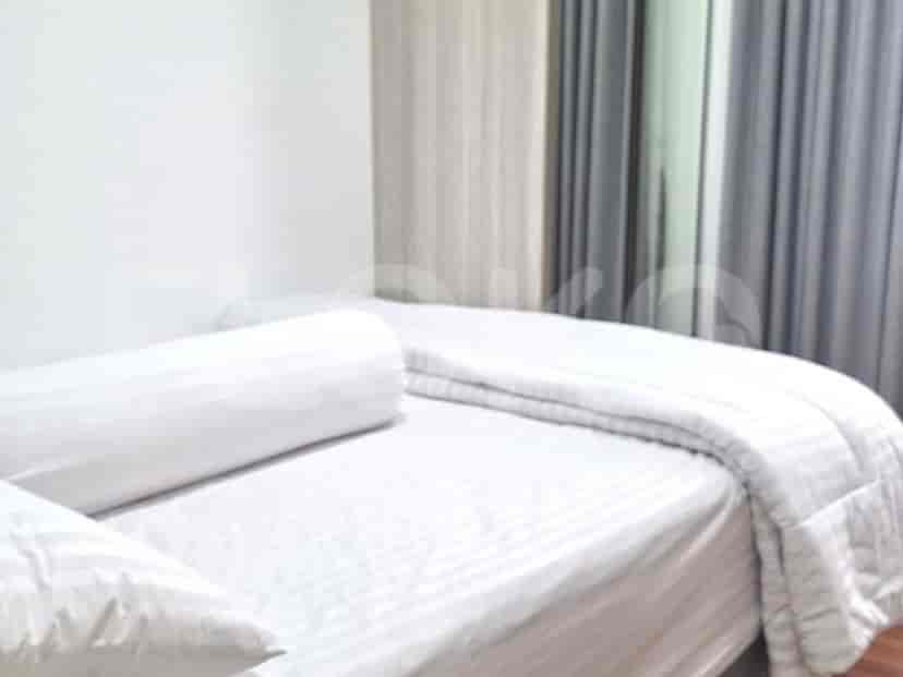 A bedroom with a bed, pillows, and a minimalist design.
