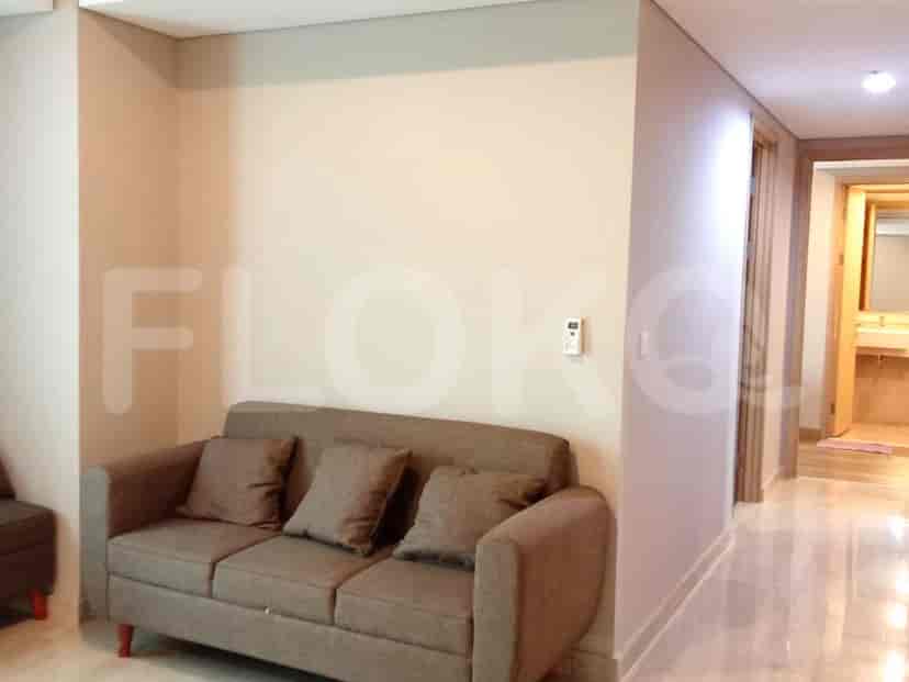 Living room with a sofa and entryway to the hallway.