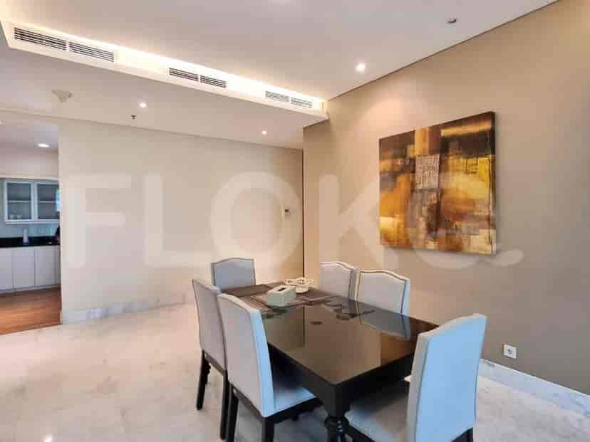 A dining room with a rectangular black dining table and six chairs.