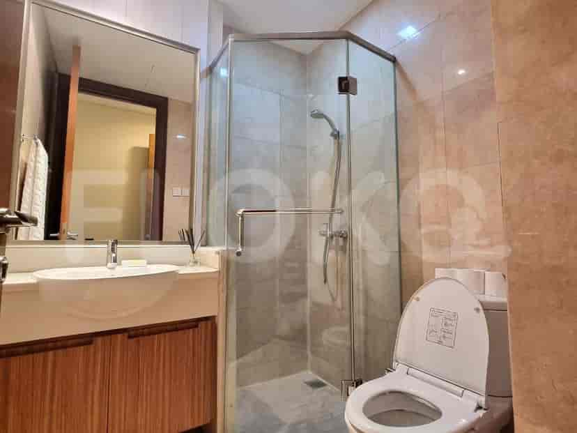 A modern bathroom with a shower, toilet, and vanity.