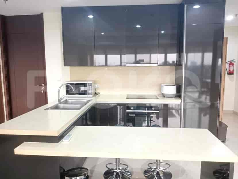 A modern kitchen with sleek cabinetry, a breakfast bar, and integrated appliances.