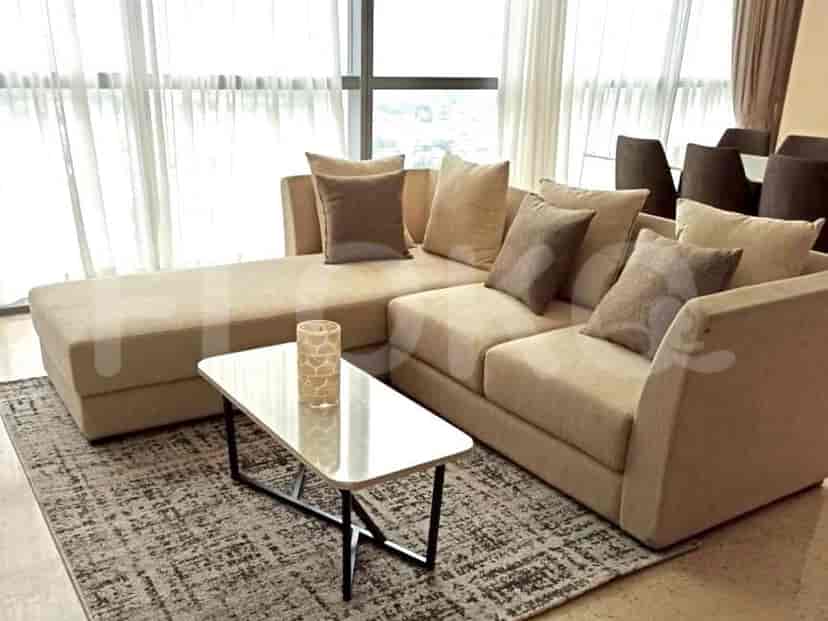 Living room with beige sectional sofa, coffee table, and area rug.