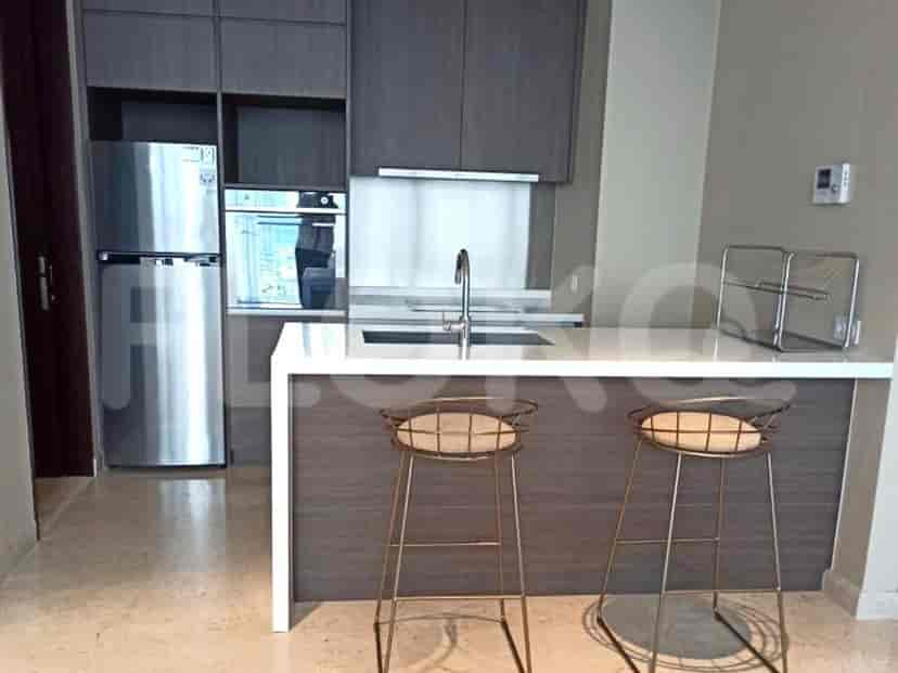 Modern kitchen with stainless steel appliances and a breakfast bar.