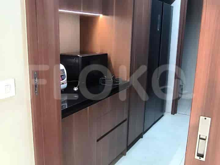 A compact kitchenette with built-in appliances.