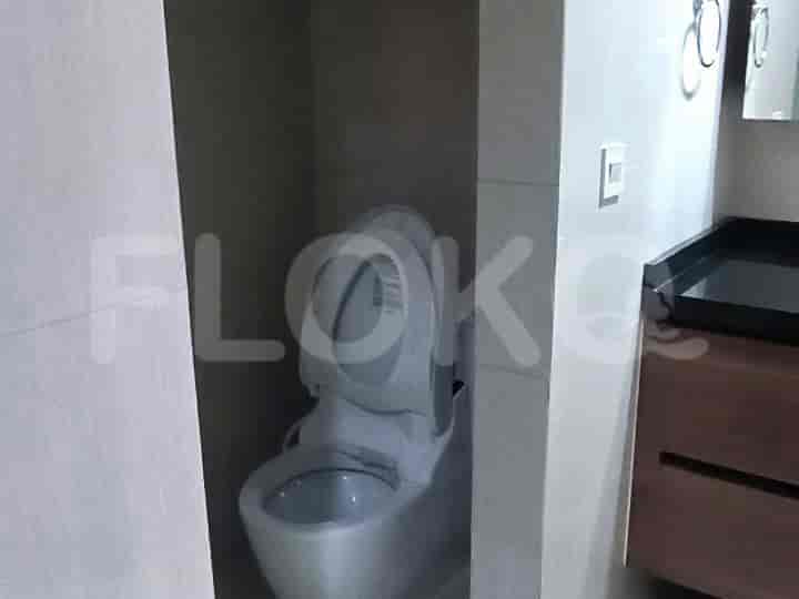 A modern bathroom with a toilet, and vanity.