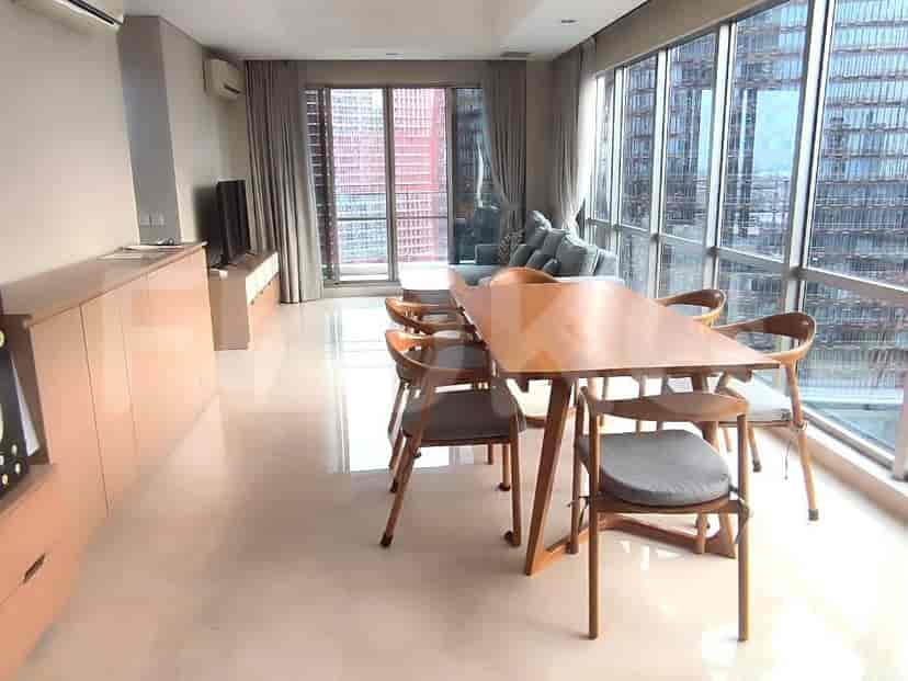 A bright dining and living area with large windows overlooking the city.