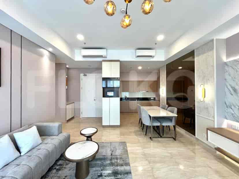 A combined dining and kitchen area featuring a marble-topped dining table, modern kitchen cabinets, and a view of the living room.