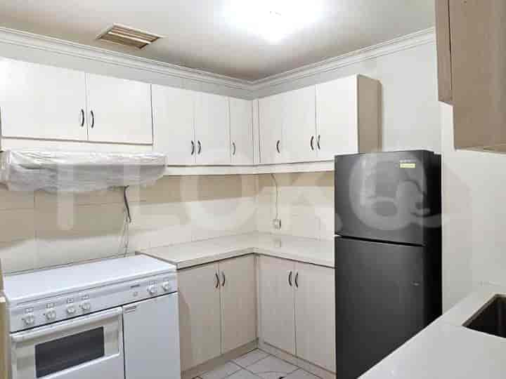 A kitchen with cabinets, a stove, and a refrigerator.