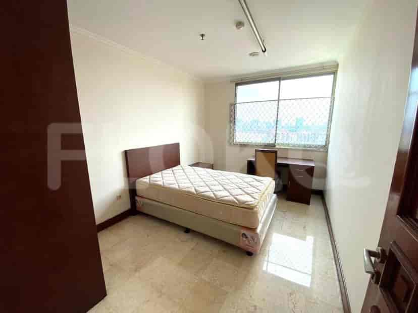 Bedroom with a bed, nightstand, and desk.