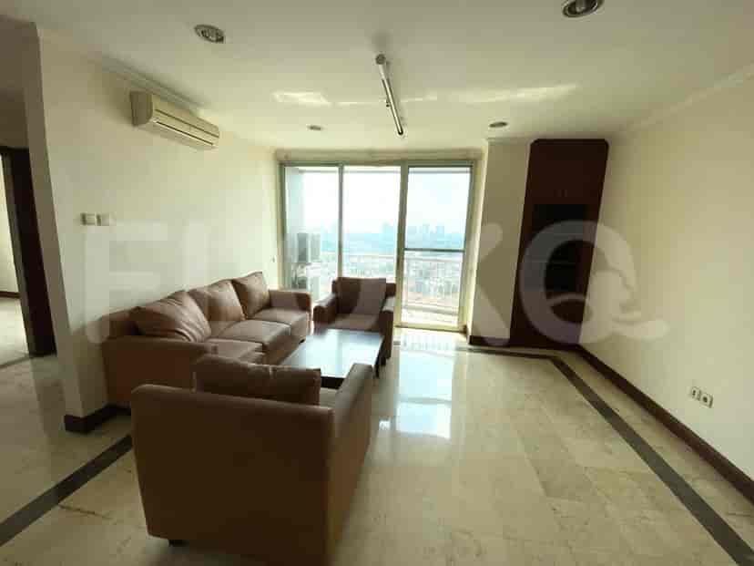 Living room with a leather sofa, two chairs, and a view outside.