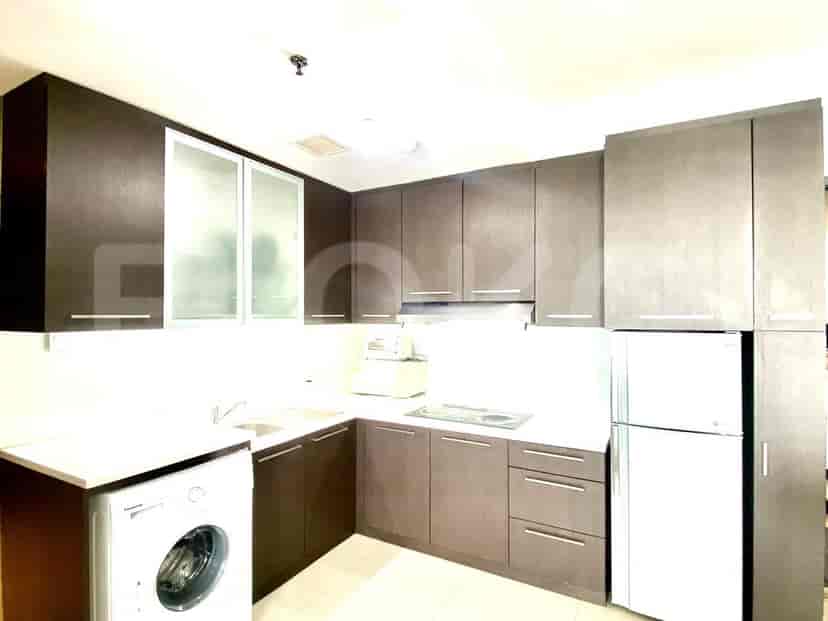 A modern kitchen with dark brown cabinets and stainless steel appliances.