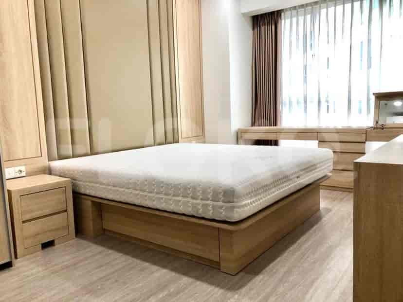 A modern bedroom featuring a large bed, wooden furniture, and elegant design.