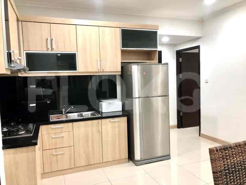 A well-equipped kitchen with wooden cabinets, appliances, and essential amenities.