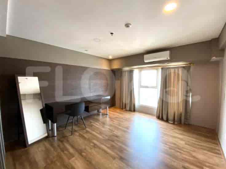A bedroom area with a desk, chair, and large mirror.