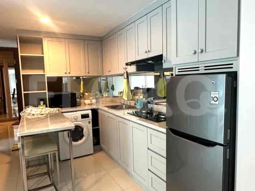 Modern kitchen with cabinets, a refrigerator, and a small dining counter.
