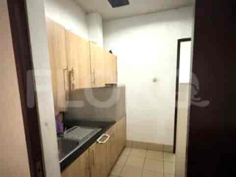 Small kitchen with wooden cabinets and stainless steel sink.